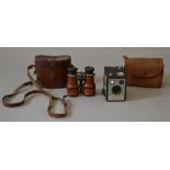 Set of leather-clad binoculars, cased together with a Brownie camera.