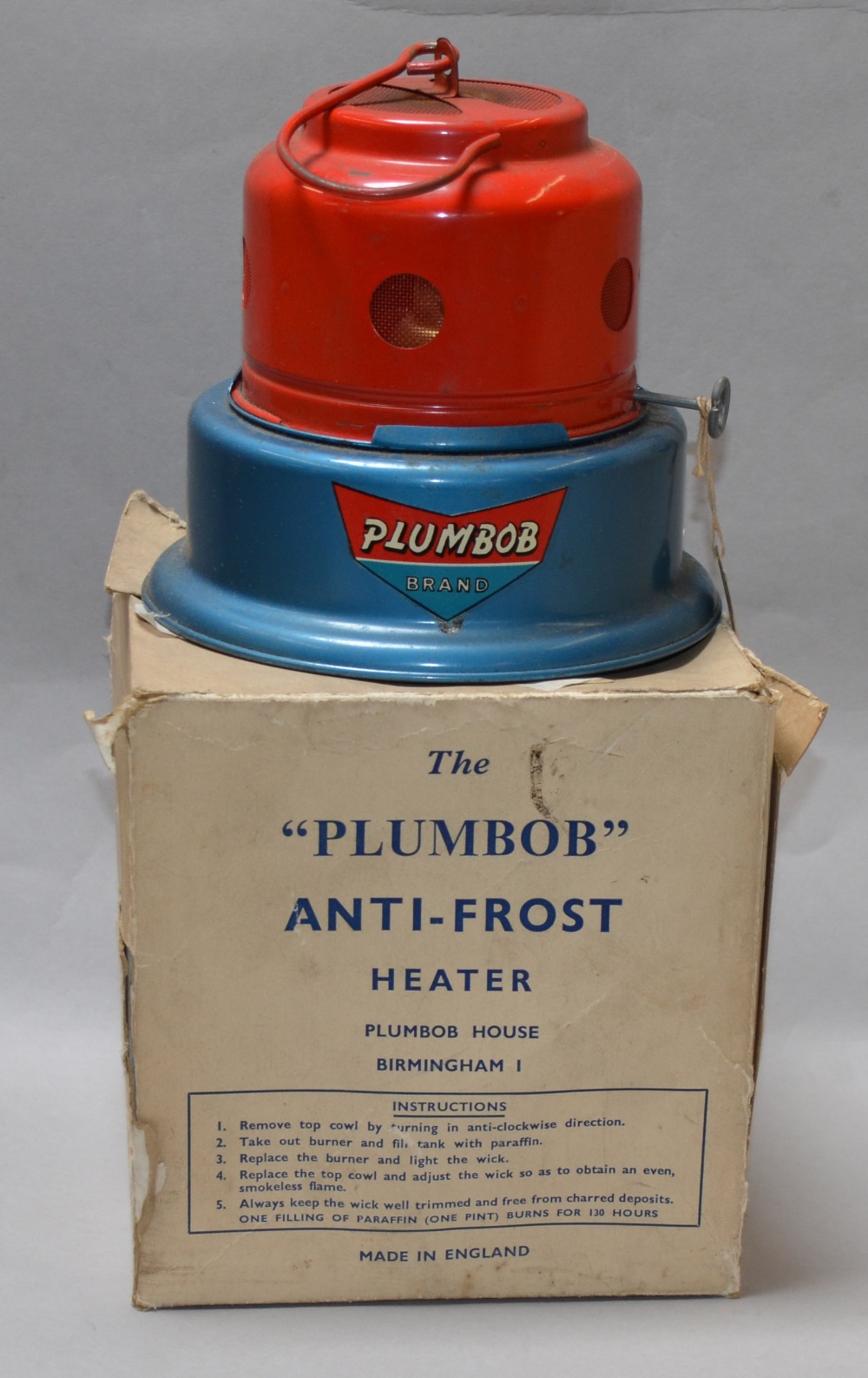 A vintage Plumbob Anti-Frost Heater in red and blue.