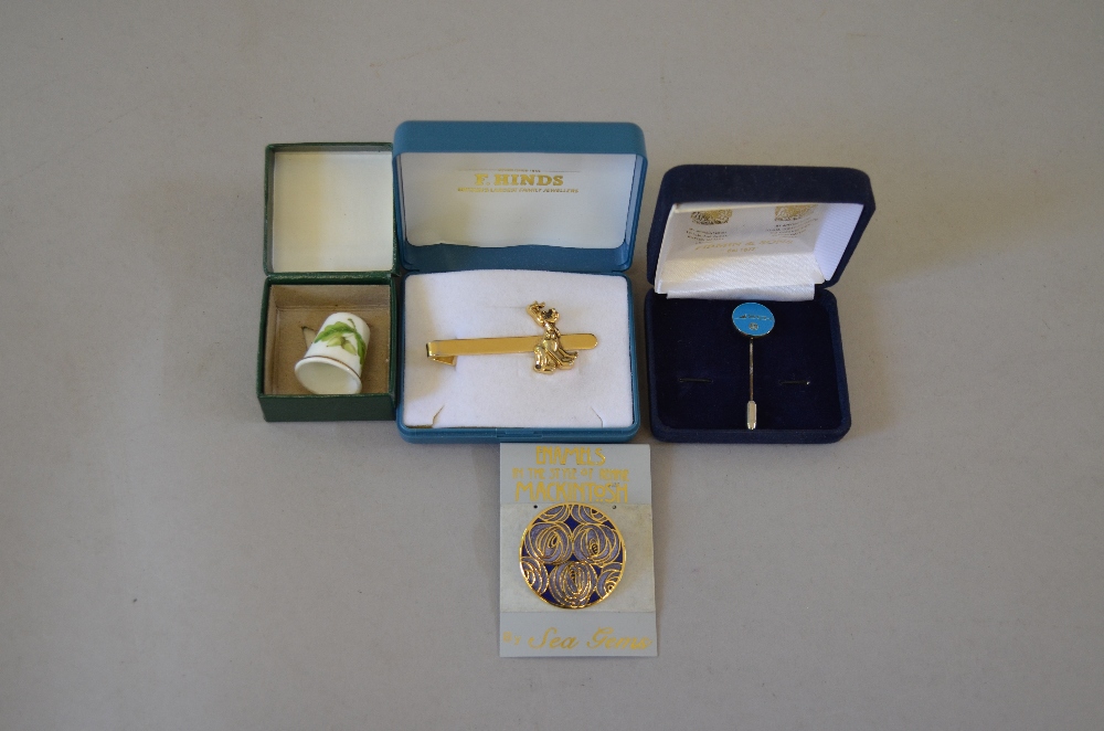 Small lot of jewellery including an enamel broach, a disney tieclip,