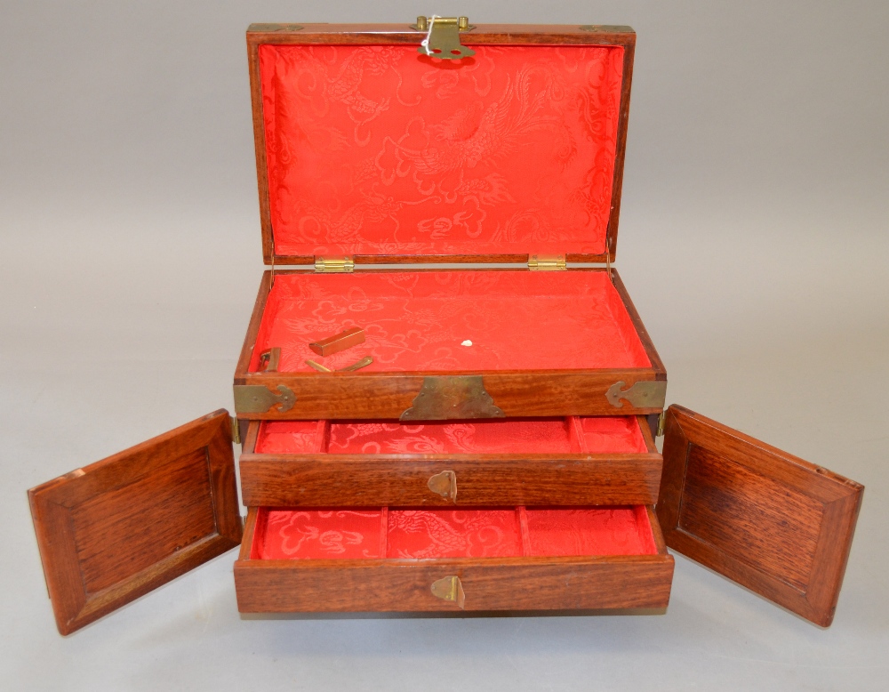 2 wooden jewellery boxes both with similar ornate decorative brass hinging and detailing,