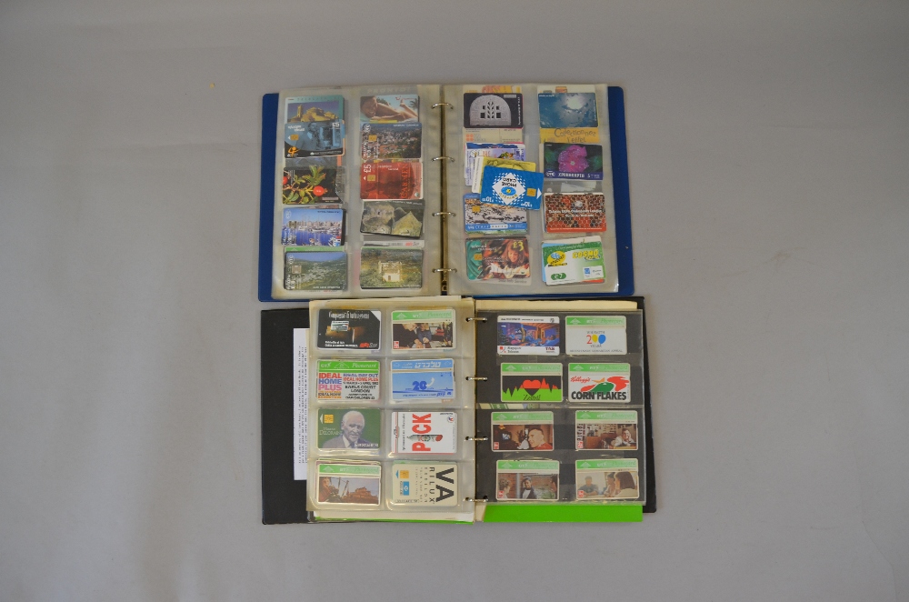 Two albums containing assorted vintage phone cards,