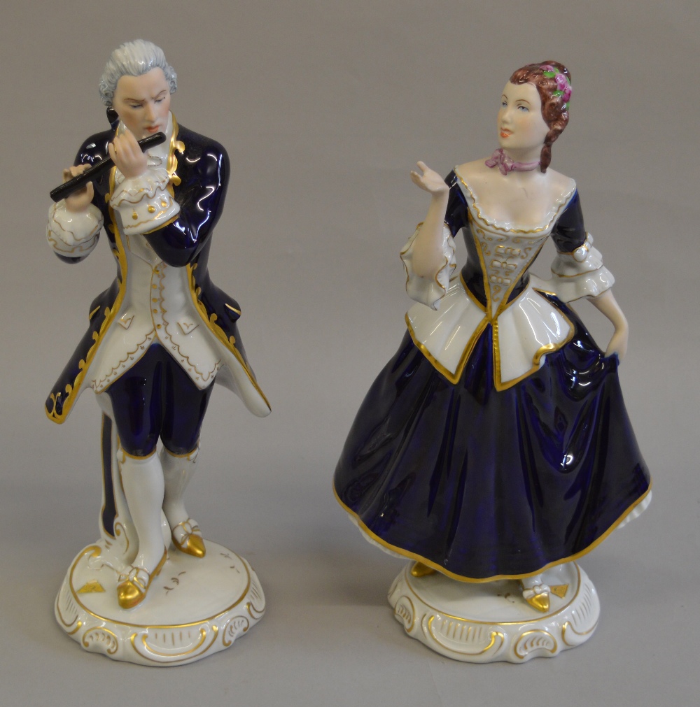 2 Royal Dux figures in period dress, male figure s/d to flute.