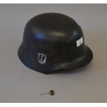 Reproduction German WWII helmet together with a related pin badge (2)