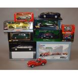 11 Assorted 1:18 and 1:24 cars and motorbikes, mostly boxed.