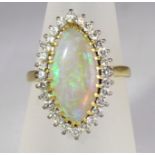 An 18ct H/M marquise shaped Opal and Diamond cluster ring, approx total diamond weight 0.