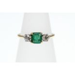 An Emerald and Diamond 3-stone ring stamped 18ct, approx total Diamond weight 0.