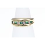 An 18ct H/M Emerald and Diamond 9-stone half eternity ring,