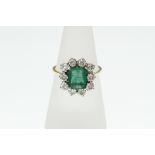 An 18ct H/M emerald and diamond cluster ring, size P, approx total diamond weight 1ct,