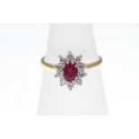 A Ruby and Diamond cluster ring, 18ct H/M, approx Diamond weight 0.50ct, approx Ruby weight 0.