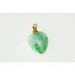 A Jade set heart shape pendant in a yellow metal mount (tested as 94%)