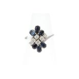 A Sapphire and Diamond cluster ring, the six Diamonds totalling approx 0.