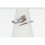 An 18ct H/M 2-stone Diamond twist set ring, approx total weight 0.