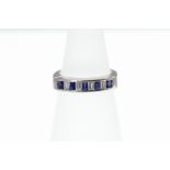 A sapphire and diamond 9 stone baguette half eternity ring stamped 750,