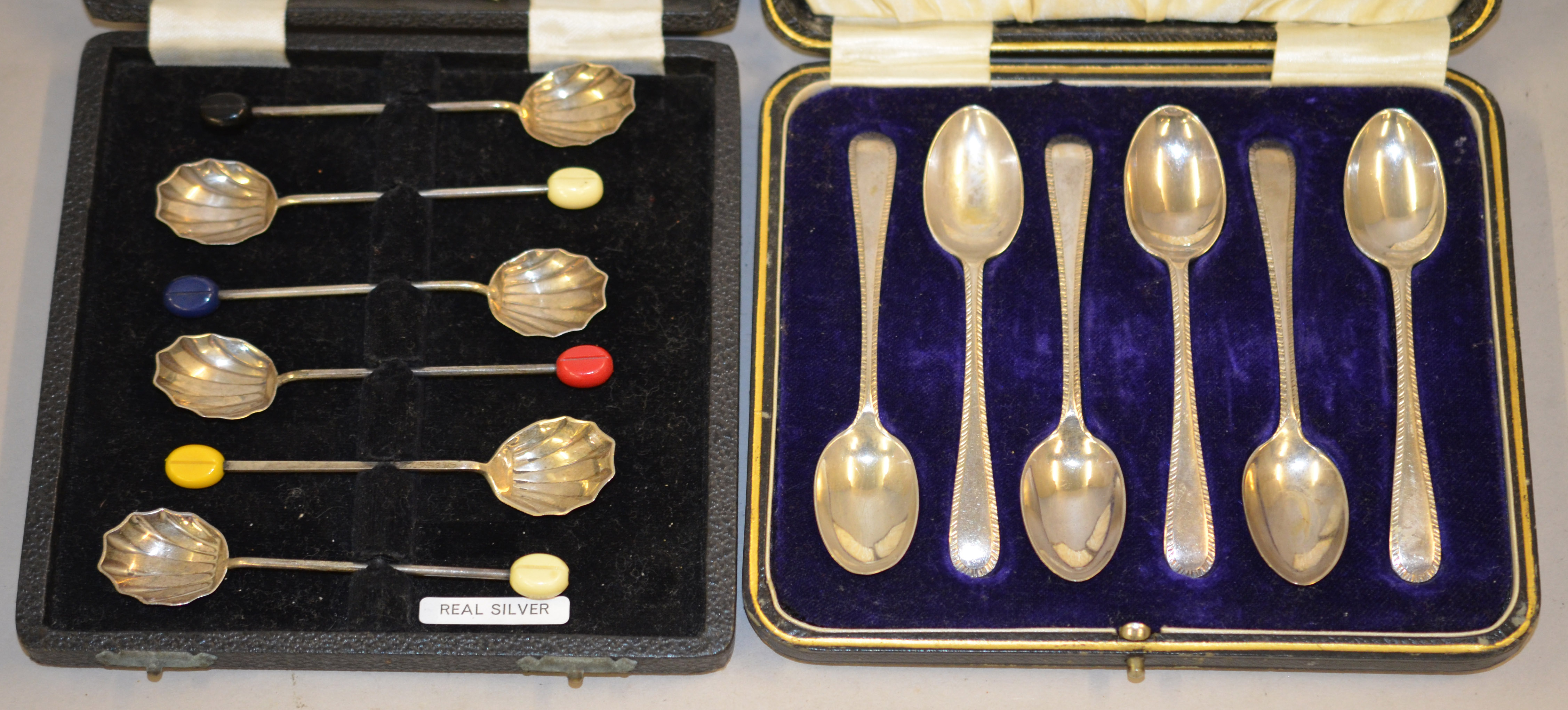 Two cased sets of 6 silver tea/coffee spoons, totalling approx 120g,