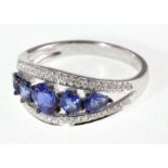 An 18uct H/M graduated sapphire & diamond ring, approx sapphire weight 1.