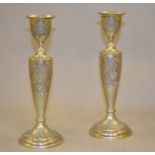 A pair of 'PERSIAN' white metal candlesticks with engraved decoration, approx 8.