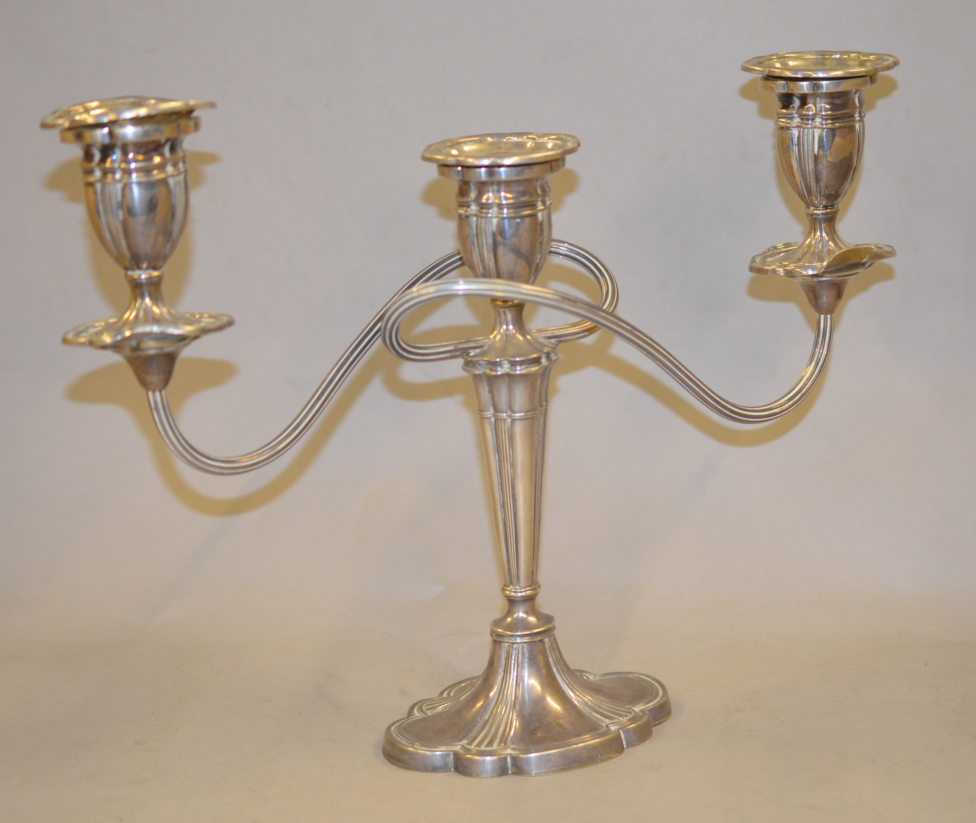 A silver two-branch candleabra with removeable sconces and fluted decoration, approx 9inch high,