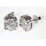 A pair of 18ct H/M white gold single stone diamond ear studs with scre back fittings,