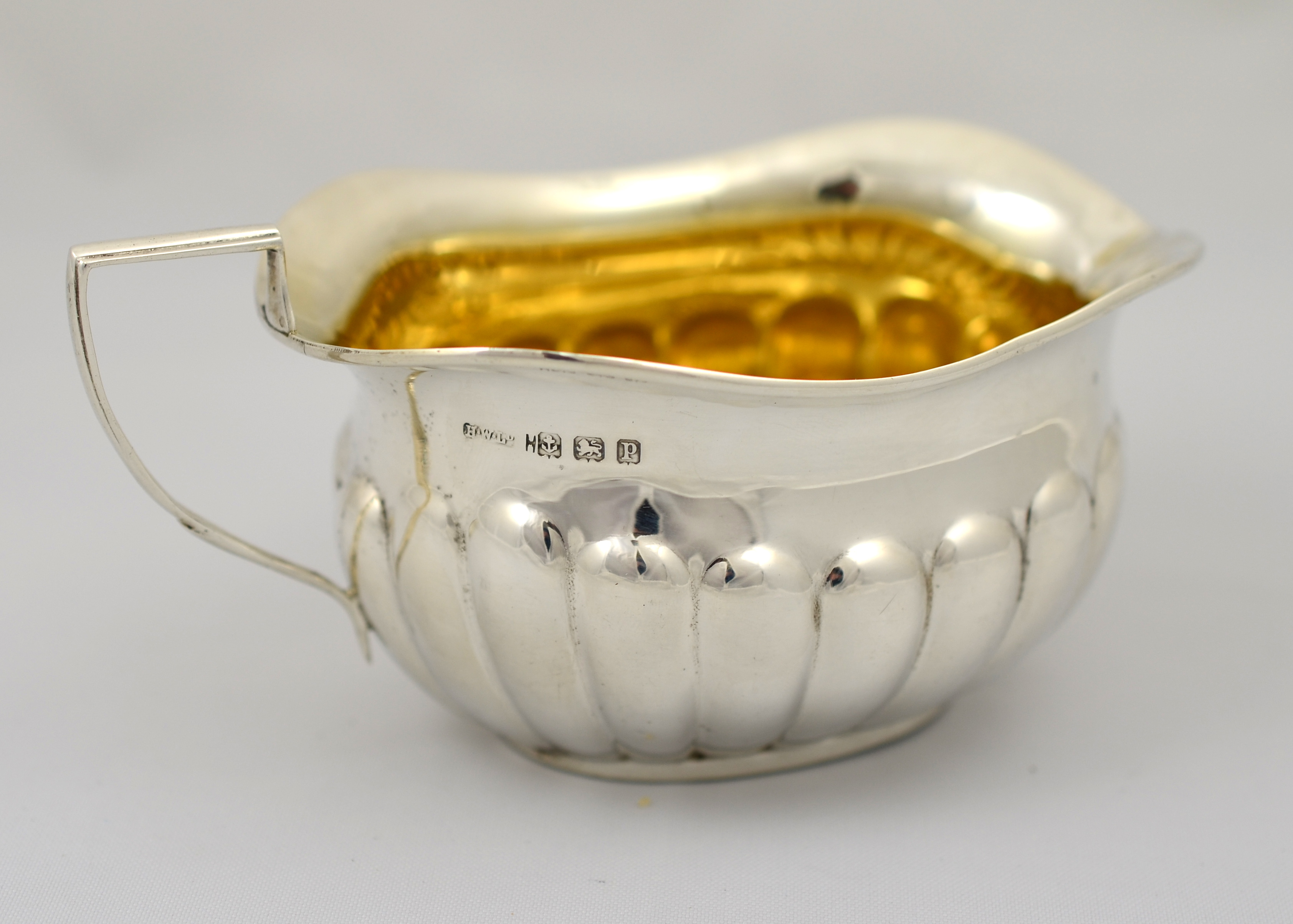 A large Silver cream jug with gilded interior, Hallmarked Birmingham 1914 and approx. 92g.