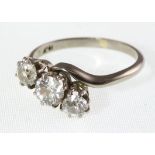 A three stone diamond twist ring, marked 18ct, approx total diamond weight 1.