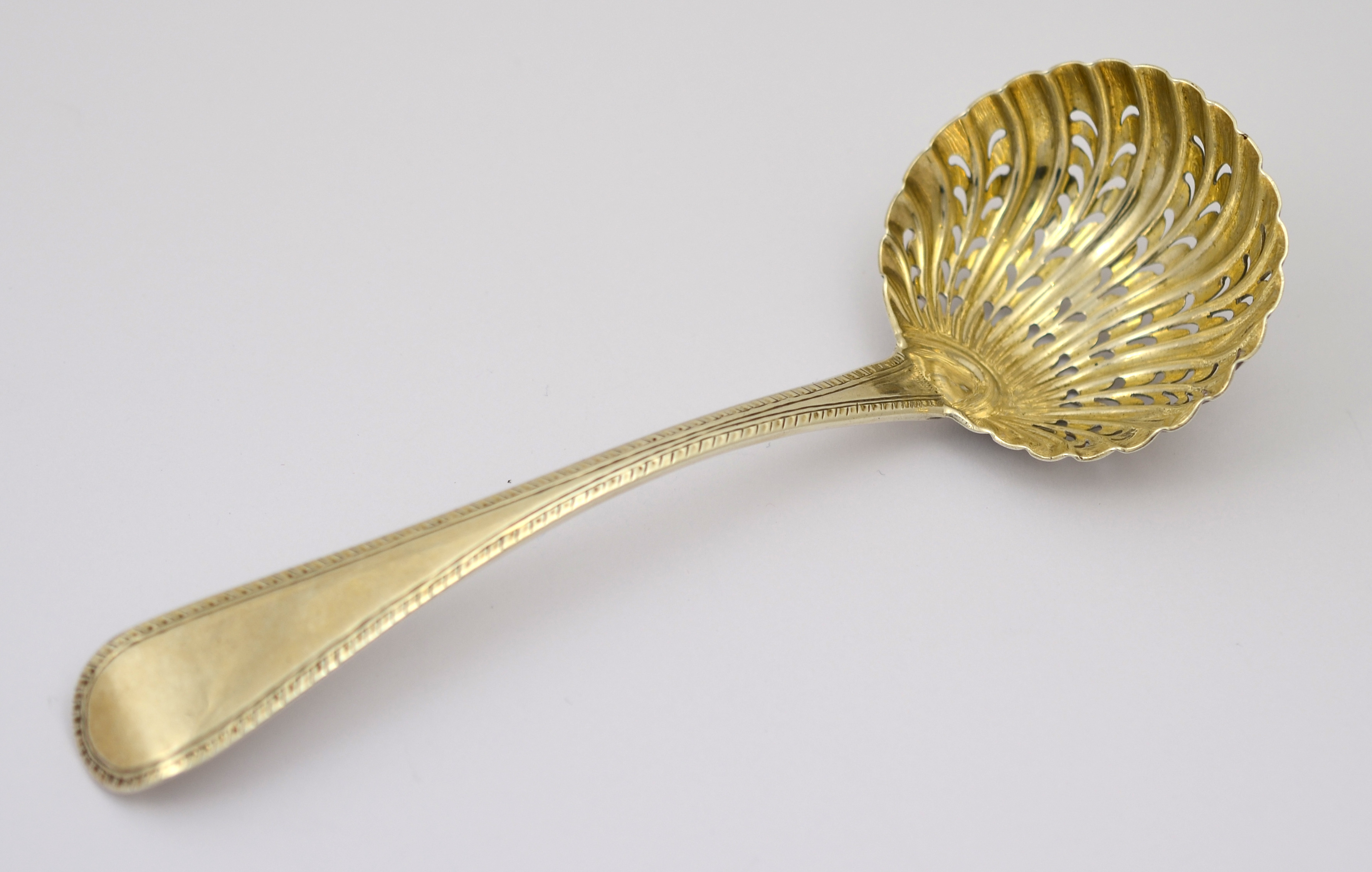 A George III silver sifter spoon, H/M London 1815,