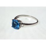 A Blue Topaz & Diamond three stone ring marked 750, total diamond weight approx 0.20ct, approx 3.