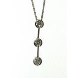 An 18ct H/M three stone diamond drop pendant & chain, approx total diamond weight 0.