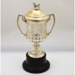 A silver two handled trophy cup & lid with fish finial & inscription, H/M Birmingham 1936,