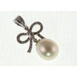 A pearl & diamond bow design pendant marked 750