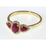 An 18ct H/M ruby & diamond three stone cluster ring, approx ruby weight 1.