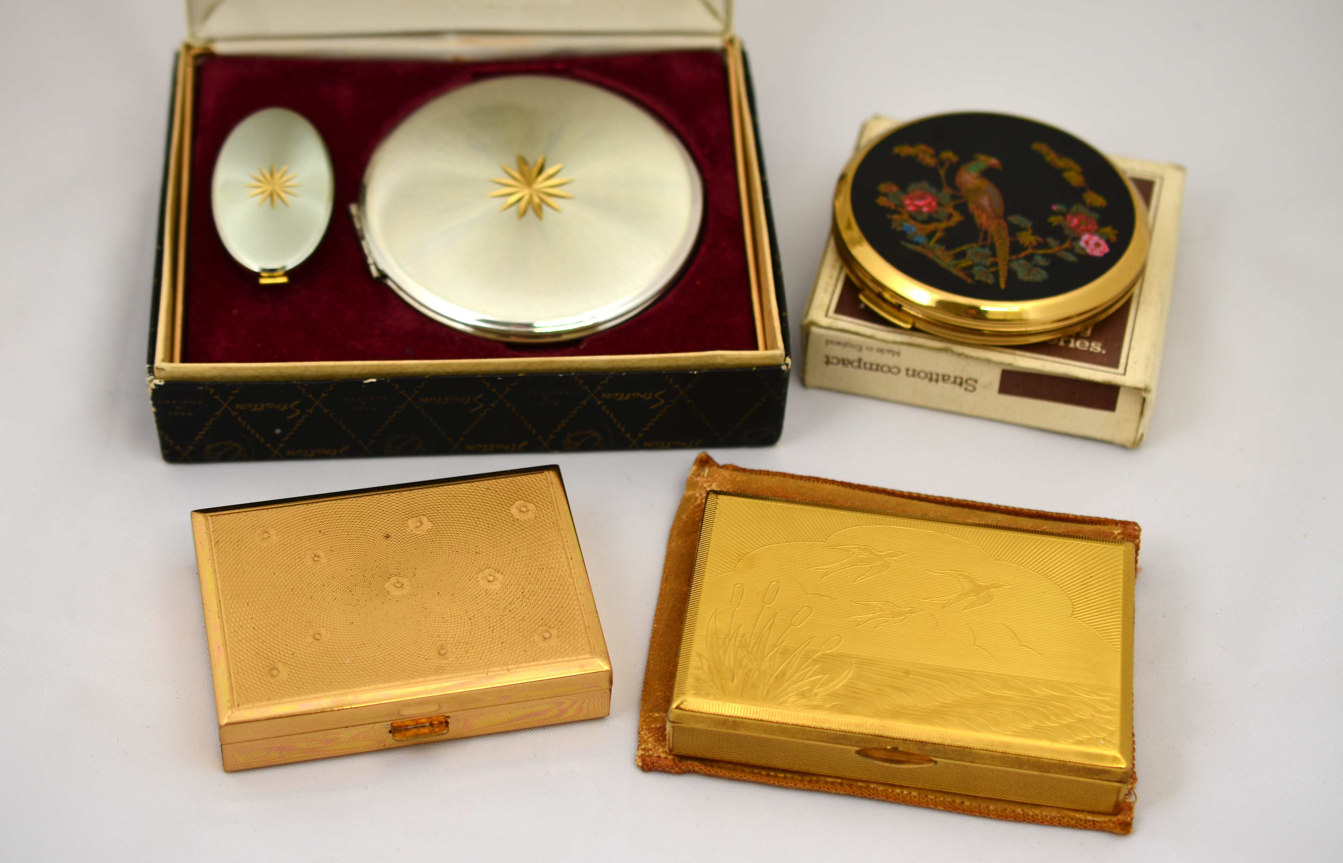 Two musical powder compacts & two others by Stralton,