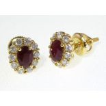 A pair of 18ct H/M ruby & diamond cluster ear studs with screw-back fittings.