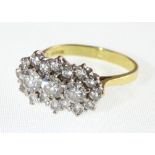 An 18ct diamond cluster ring, the three centre round brilliant cut stones approx 0.