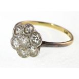 A Diamond 7-stone daisy cluster ring, market '8ct plat'. Approx. total Diamond weight 1.50ct.