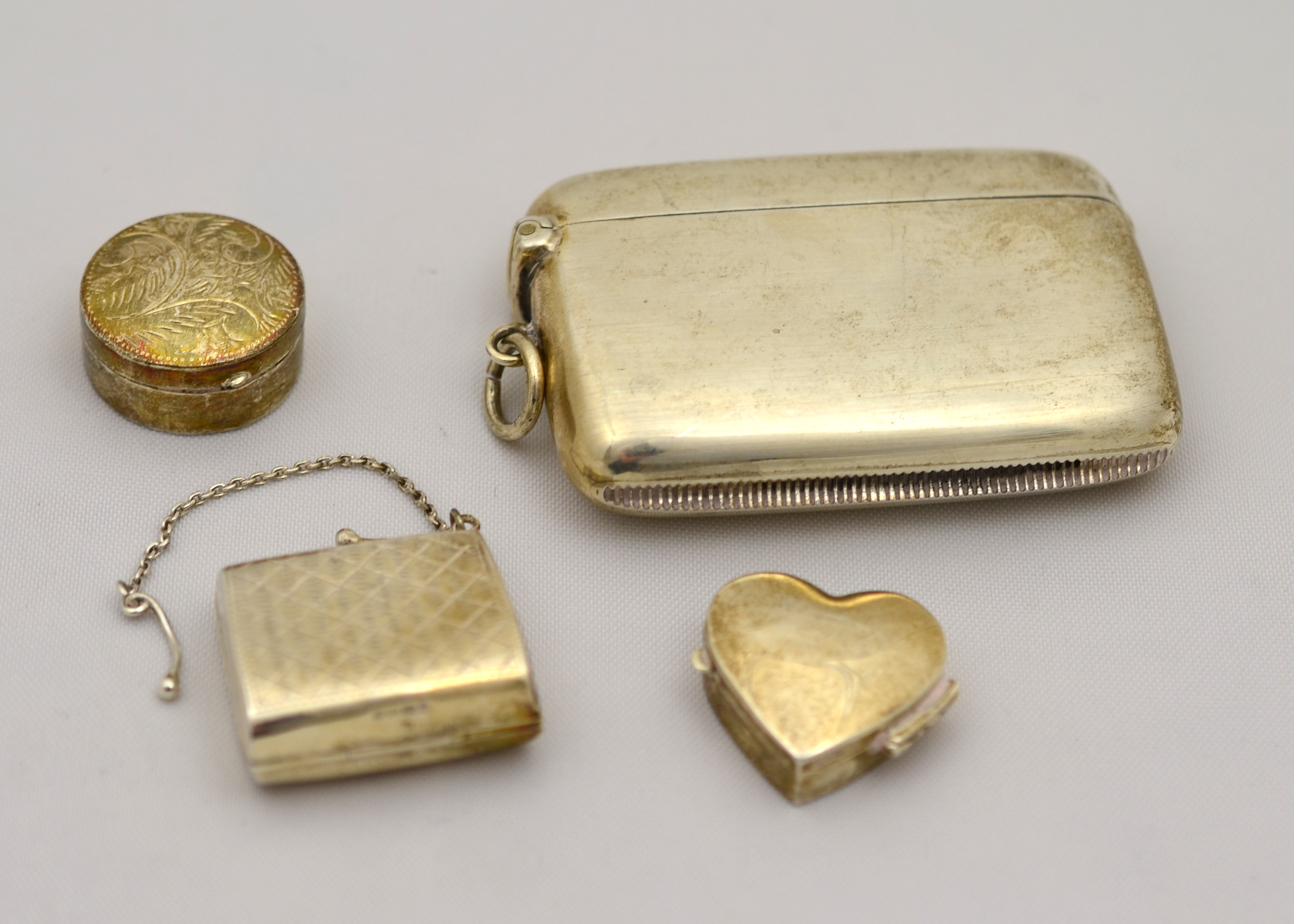 A plain silver double sized vesta case H/M Chester 1904 together with three modern silver boxes,