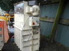 Upright cardboard baler.