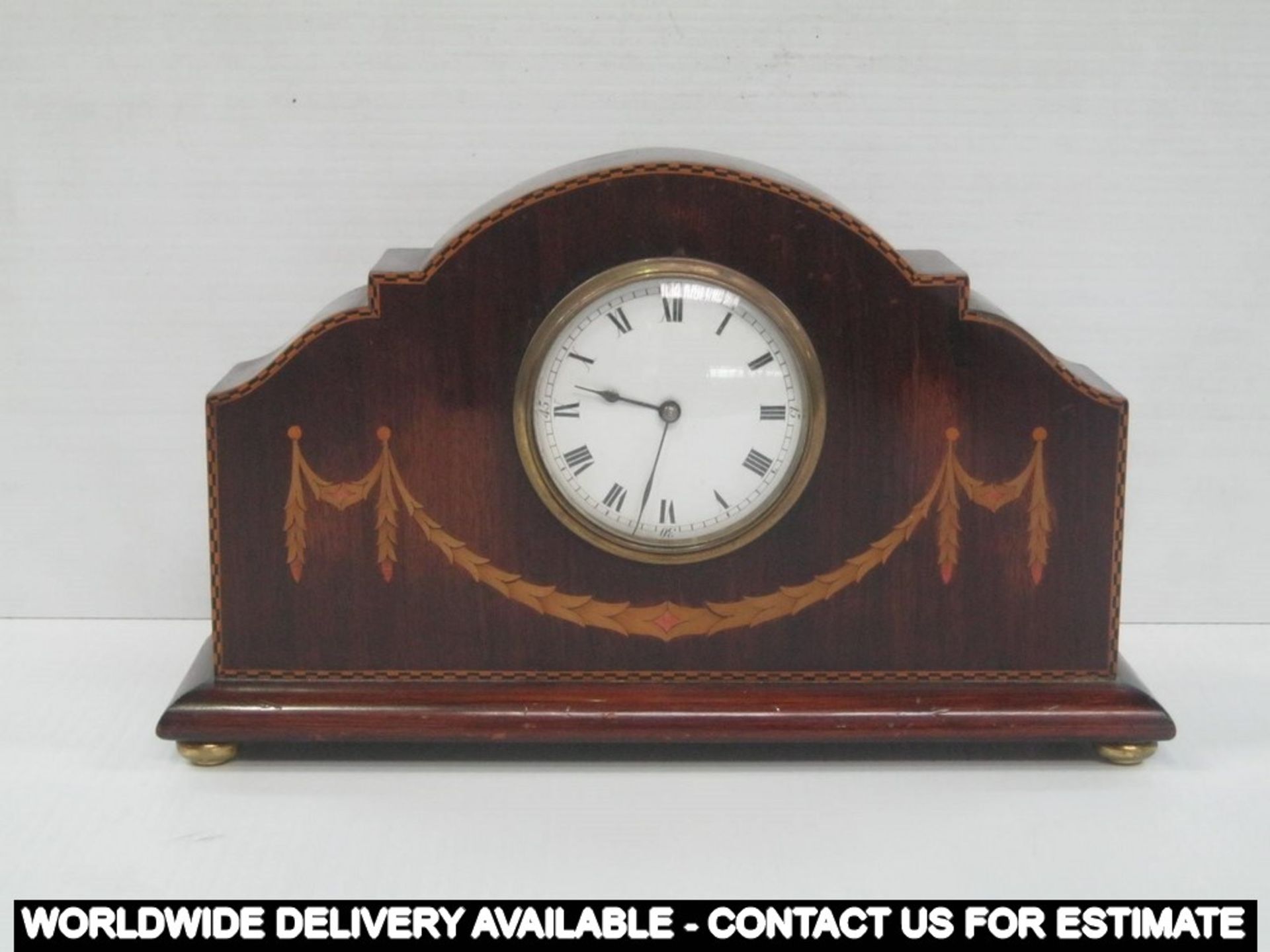 An Edwardian mahogany mantle clock with boxwood swag inlay