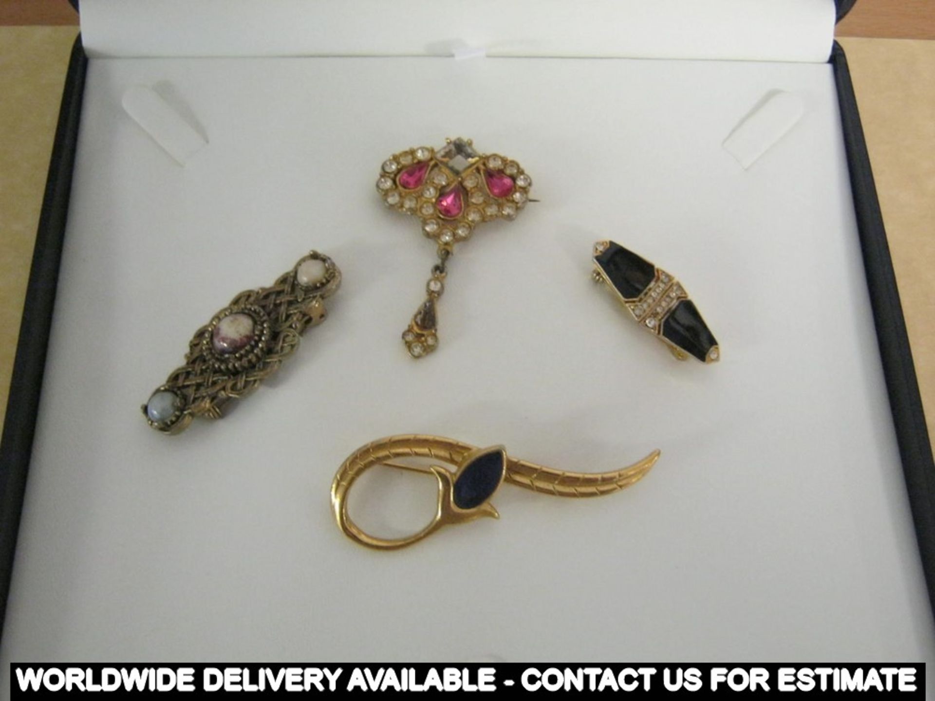 Four vintage brooches in presentation box