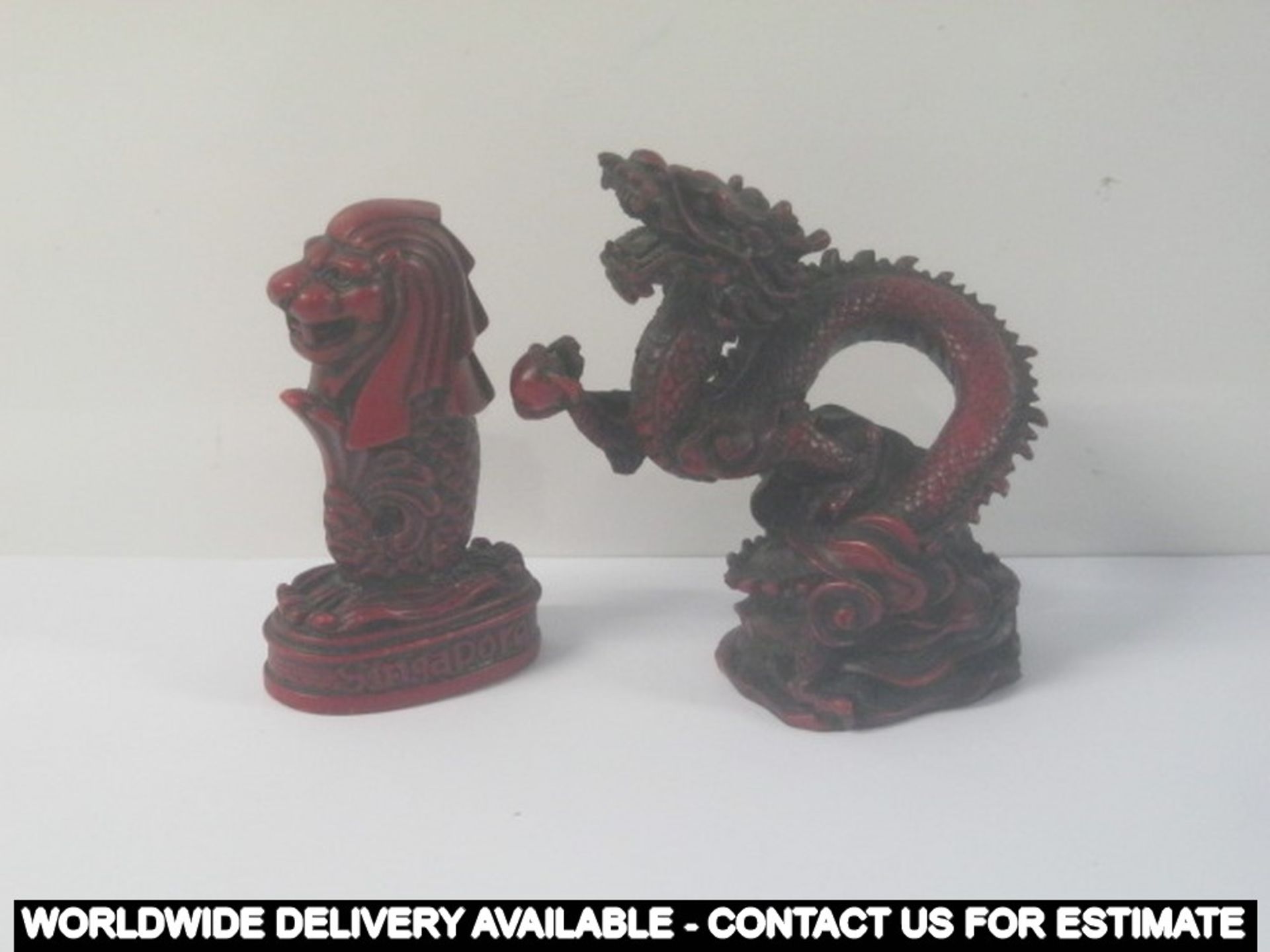 2 x red resin dragons - one marked SINGAPORE and MERLION