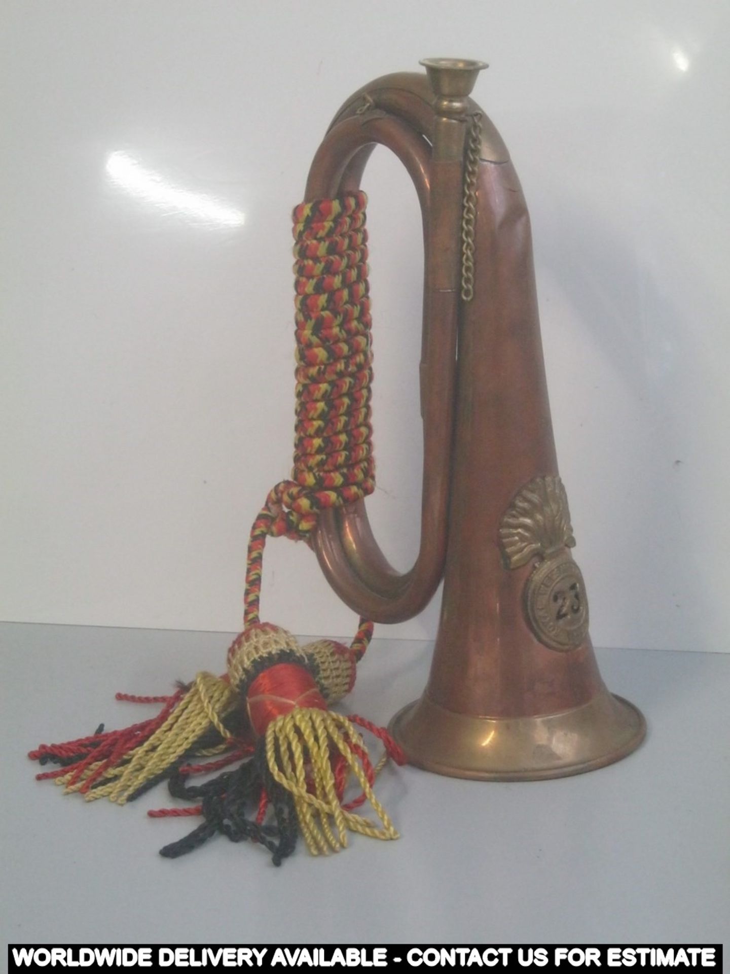 Reproduction brass and copper bugle with military crest