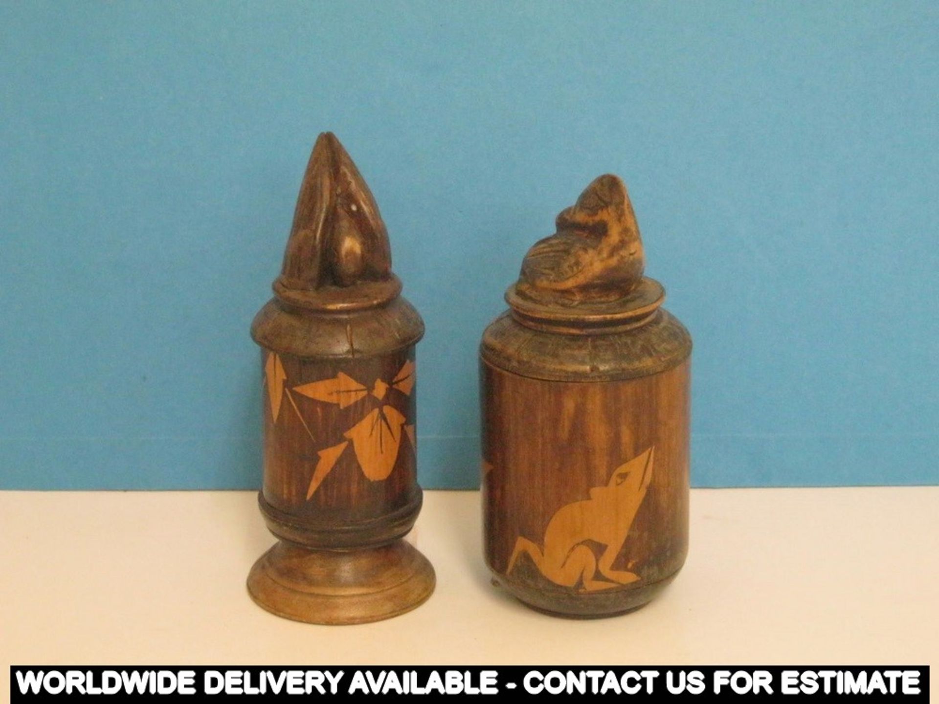 Two wooden pots with carved lids