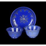 A SET OF OPAL GLASS  Bohemia, 18th century. Two tea cups and a bowl of opaque blue enamel, decorated