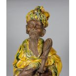 A late 19th / early 20th Century Chinese terracotta figure of a standing bearded Sage, the