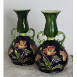 A pair of late 19th/early 20th Century pottery two handled vases in the ‘Moorcroft’ manner,