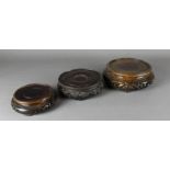 A late 19th / early 20th Century stained hardwood circular vase stand, carved in relief and