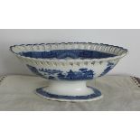 An early 19th Century English blue and white transfer printed pottery oval pedestal bowl, with