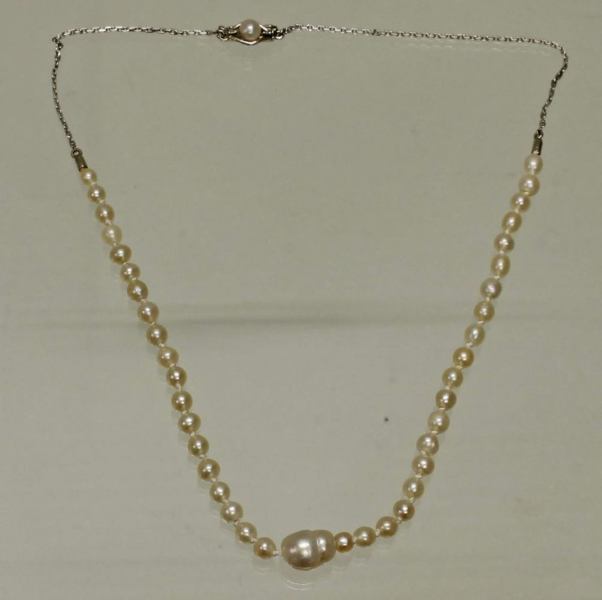 Reserve: 240 EUR        Perlcollier, wohl 40 natürliche Perlen, 1 barocke Mittelperle, Kette und