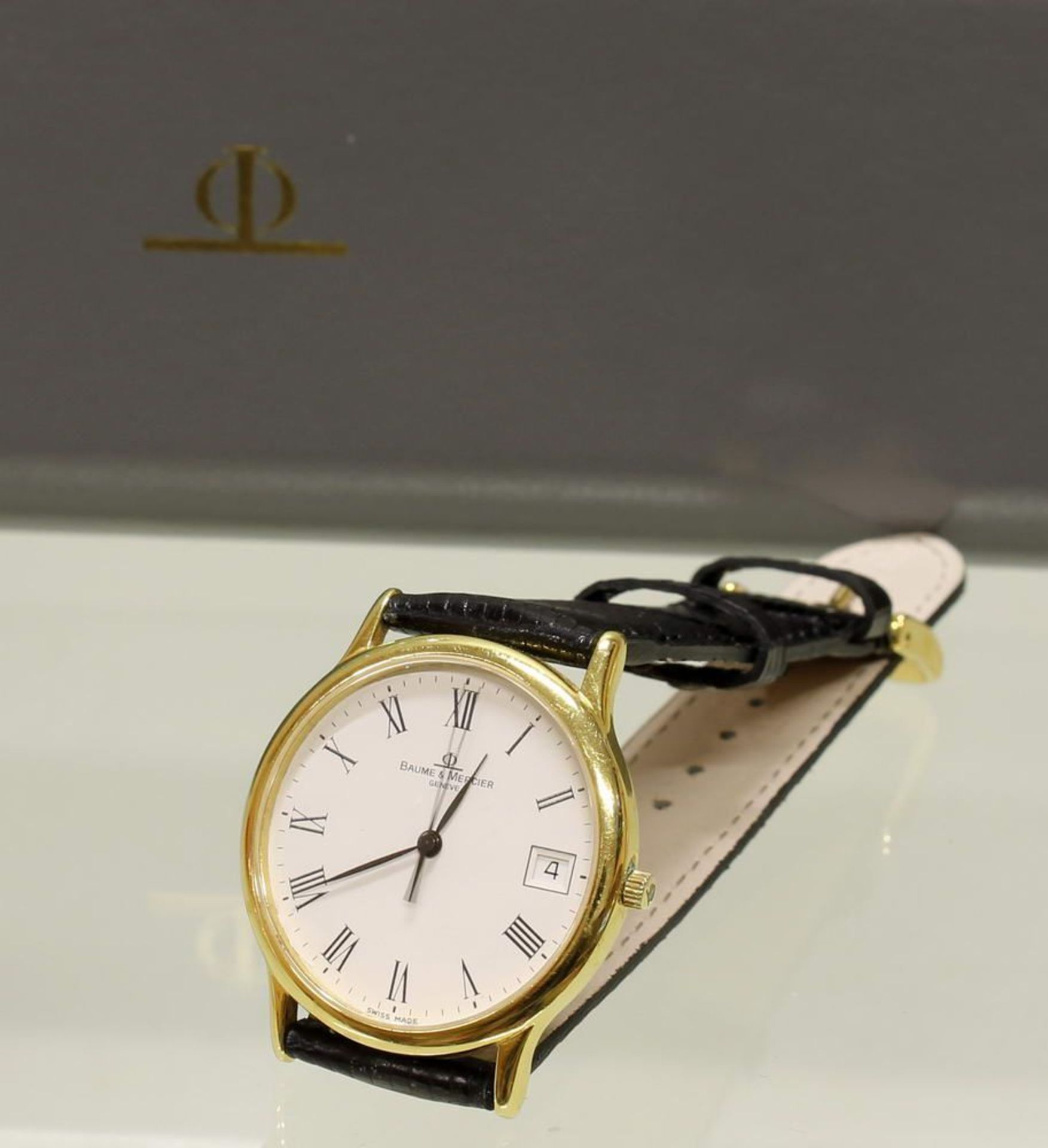 Reserve: 500 EUR        Armbanduhr, Baume & Mercier, GG 750, Quarzwerk, weißes Zifferblatt, römische
