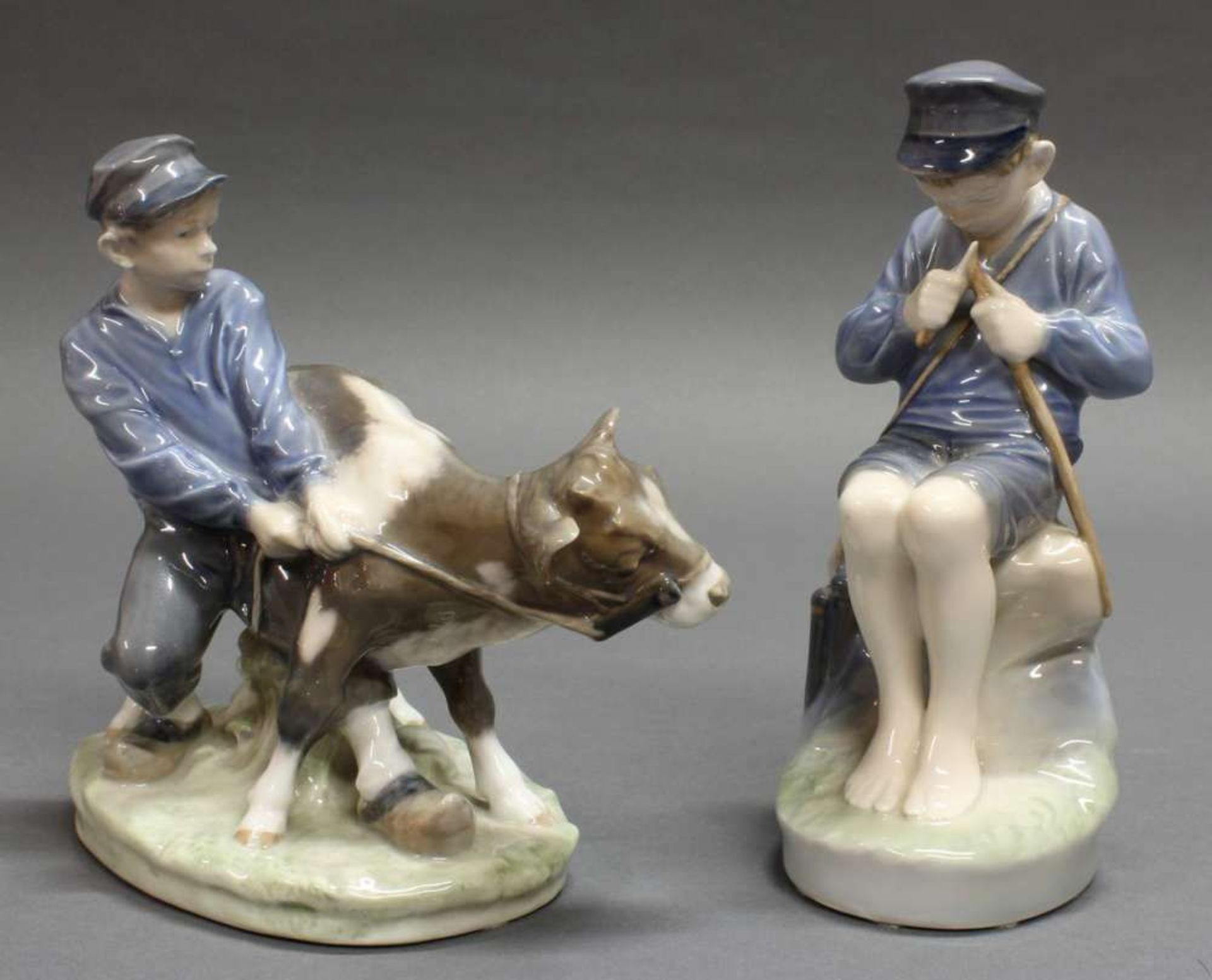 Reserve: 120 EUR        2 Porzellanfiguren, "Junge mit Kälbchen", "Schnitzender Junge", Royal