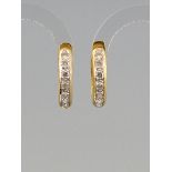Pair of hoop earrings 18ct. yellow gold, together 14 diamonds, diam. Each 18.5 mm, total weight 5.